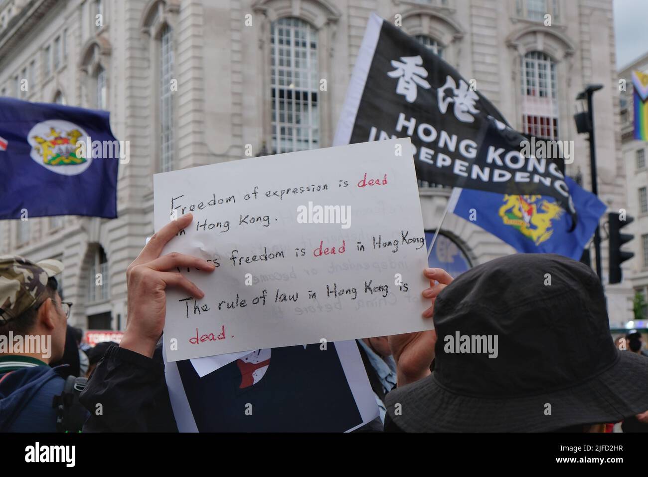 London, UK, 1st July, 2022. Hong Kong pro-democracy activists held a rally outside the Hong Kong Trade & Economic Office on the 25th anniversary of the British handover back to China, when it was agreed that territory would retain civil liberties under the principle of 'one country, two systems', for 50 years after 1997.   Growing concern over the crackdown on protest, closure of several news outlets, and the introduction of the national security law have led to some Western nations' criticism of interference by Beijing authorities. Credit: Eleventh Hour Photography/Alamy Live News Stock Photo