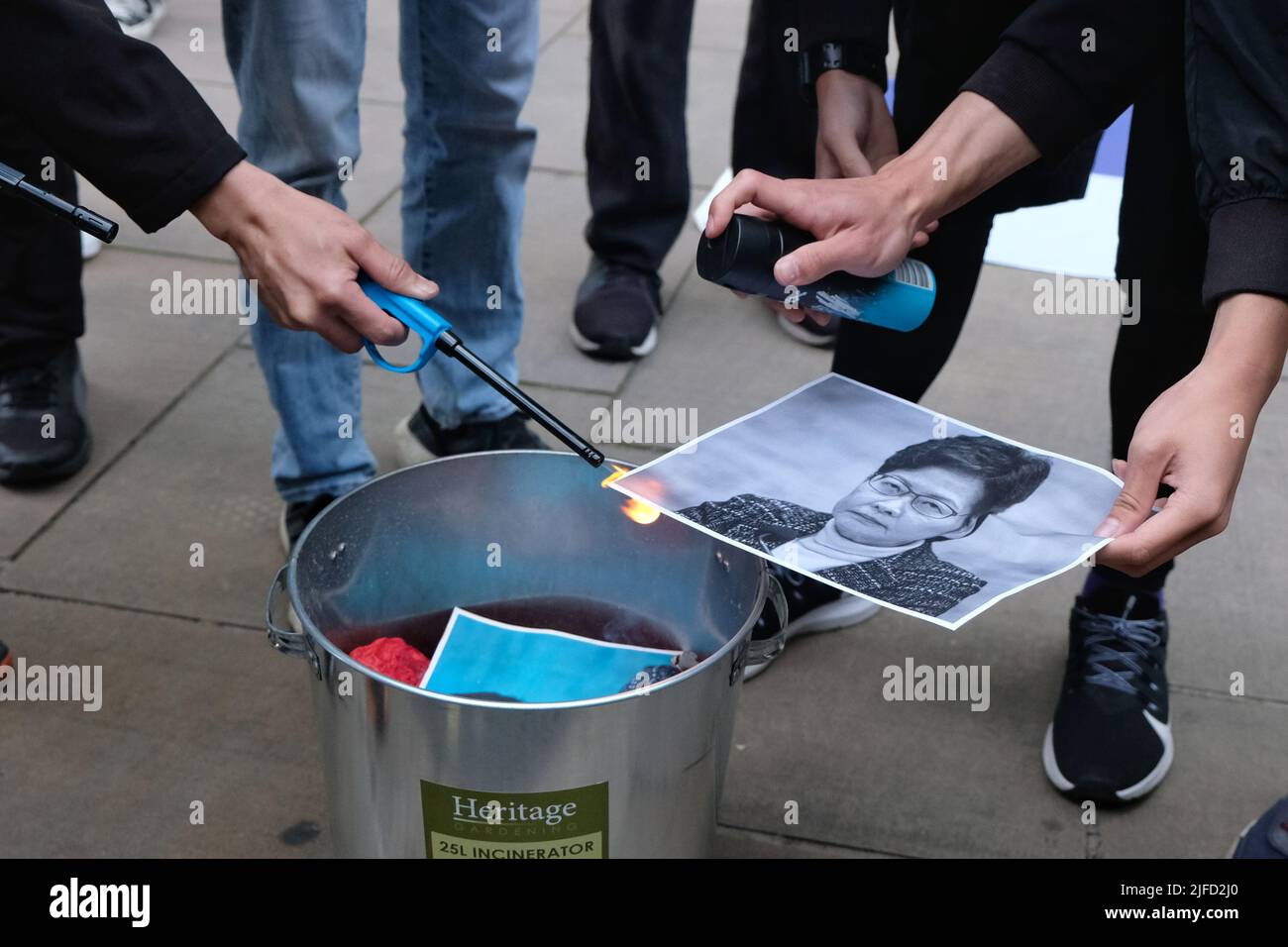 London, UK, 1st July, 2022. Hong Kong pro-democracy activists burnt portraits of Carrie Lam during a rally outside the Hong Kong Trade & Economic Office on the 25th anniversary of the handover back to China, when it was agreed that territory would retain civil liberties under the principle of 'one country, two systems', for 50 years after 1997. Growing concern over the crackdown on protest and the introduction of the national security law have led to some Western nations' criticism of interference by Beijing authorities. Credit: Eleventh Hour Photography/Alamy Live News Stock Photo