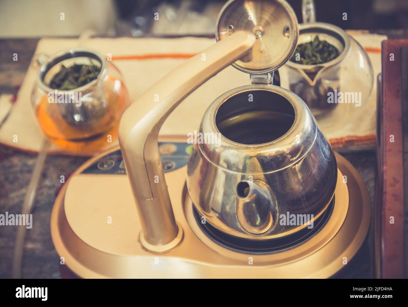 Abstract blurred kettle and a glass of tea in the coffee shop - vintage ...