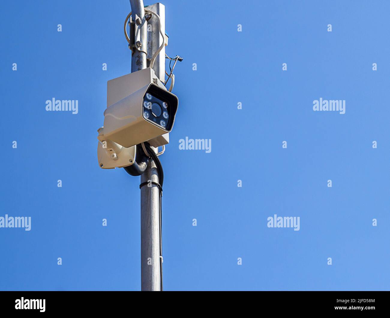 The security camera against blue sky background Stock Photo - Alamy