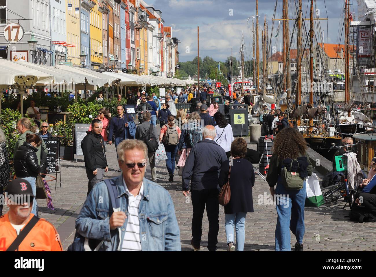Copenhagen, Denmark - June 14, 2022: People at the Nyhavn harbor in donwntown Copenhagen. Stock Photo