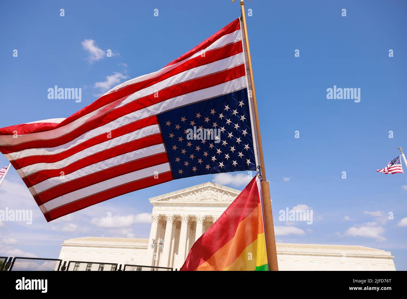 Washington, United States. 26th June, 2022. An American flag flies upside down next to a Pride flag outside the Supreme Court during a two day protest. More than 100 demonstrators gathered outside the Supreme Court of United States for an abortion rights rally. The rally comes one week after the Supreme Court of the United States issued its opinion in Dobbs v. Jackson Women's Health Organization which overturned Roe v. Wade and the right to abortion access. (Photo by Jeremy Hogan/SOPA Images/Sipa USA) Credit: Sipa USA/Alamy Live News Stock Photo