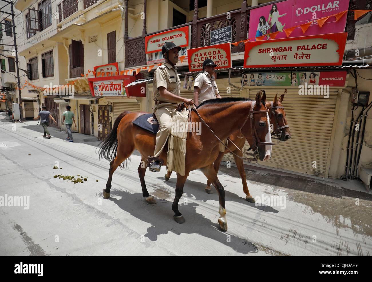 Policemen mounted on their horses patrol during restrictions imposed by authorities after the killing of Kanhaiya Lal Teli, a Hindu tailor, carried out by two suspected Muslim men who filmed the act and posted it online, in Udaipur in the northwestern state of Rajasthan, India, July 1, 2022. REUTERS/Amit Dave Stock Photo