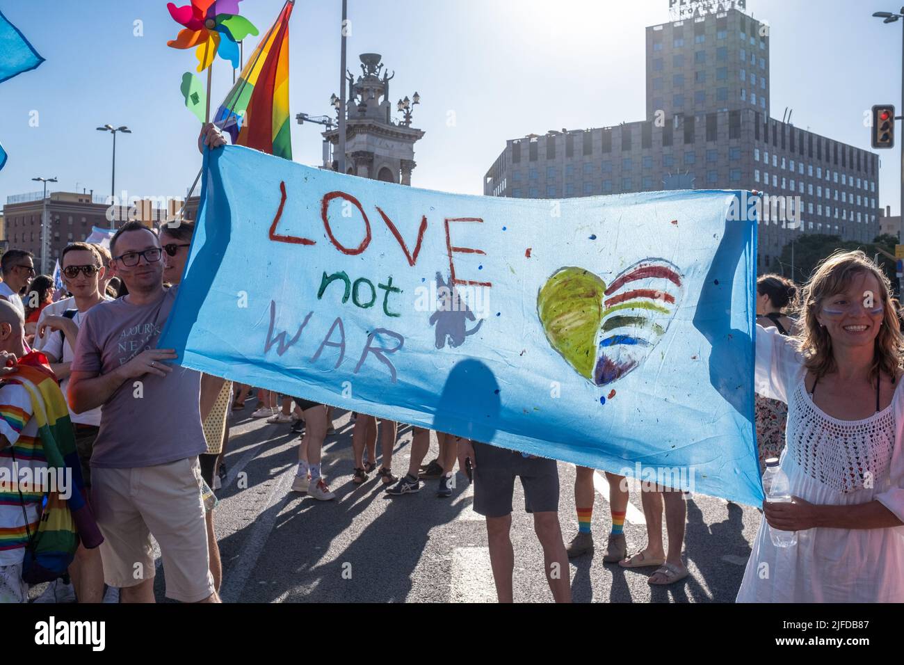 Barcelona, Spain 06-25-2022: Pride 2022 celebration in Plaza de España. A group sympathizing for gay rights displayed a banner saying 'Love not War'. Stock Photo