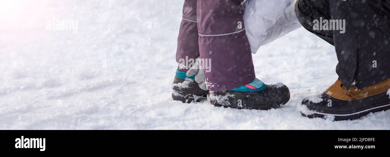 Winter shoes in the snow. Close-up of winter shoes. Children's waterproof shoes for walking in the snow. Low temperature and falling snow Stock Photo