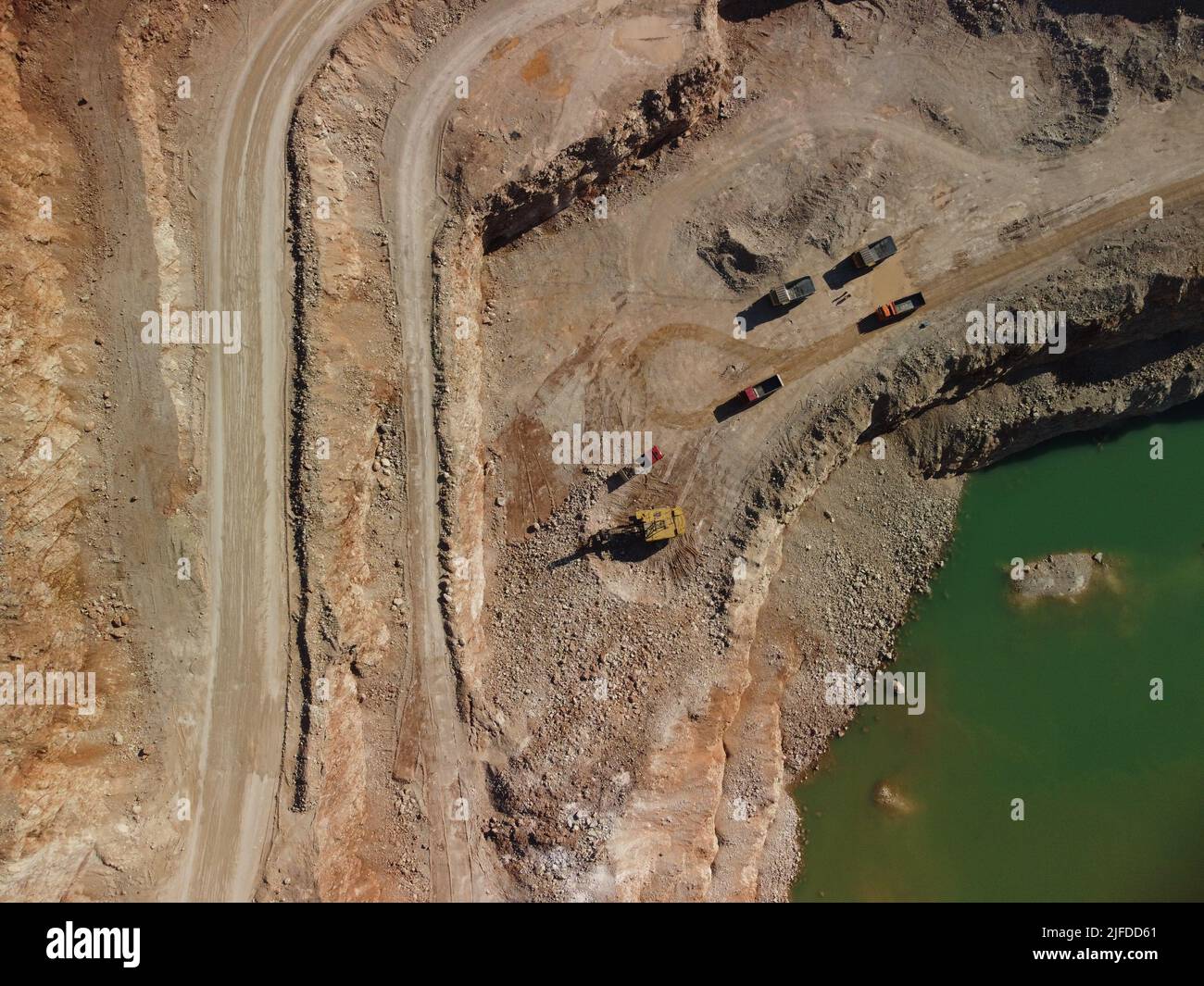 Aerial view of industrial opencast mining quarry with lots of machinery