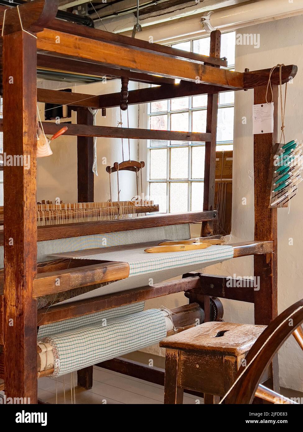 A simple handoperated loom. A loom is a device used to weave cloth and
