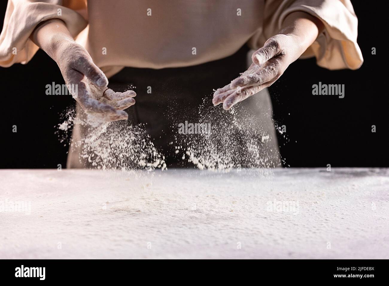 Sprinkle the flour evenly on the kitchen counter, the process of making Chinese traditional cuisine three fresh dumplings - stock photo Stock Photo