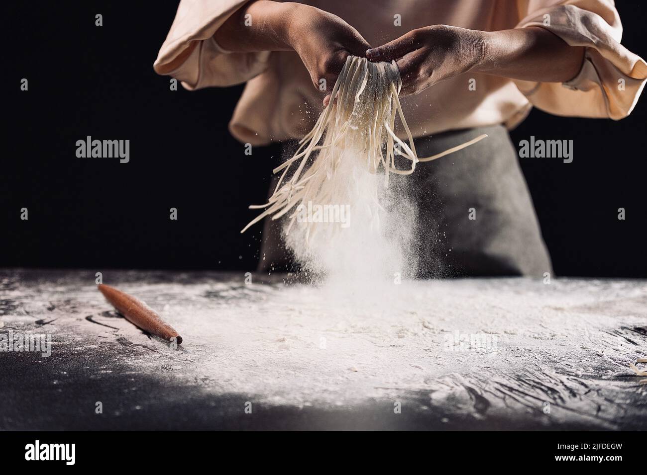 Shaking out the cut noodles, the process of making traditional Chinese