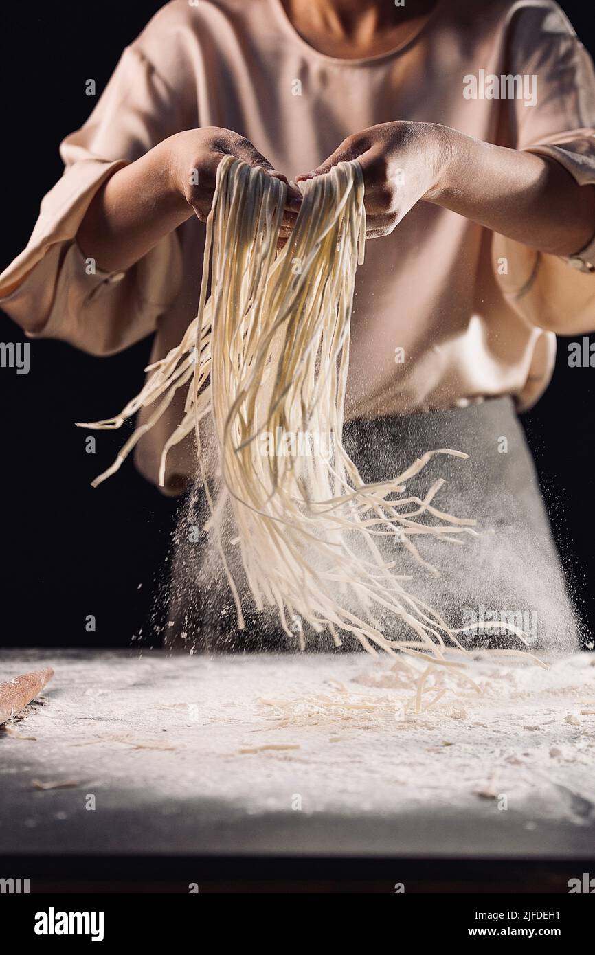 Shaking out the cut noodles, the process of making traditional Chinese