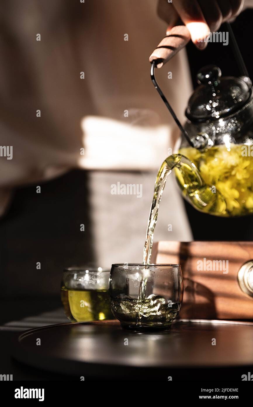 Tea artist pouring pure jasmine tea, a traditional Chinese beverage - stock photo Stock Photo
