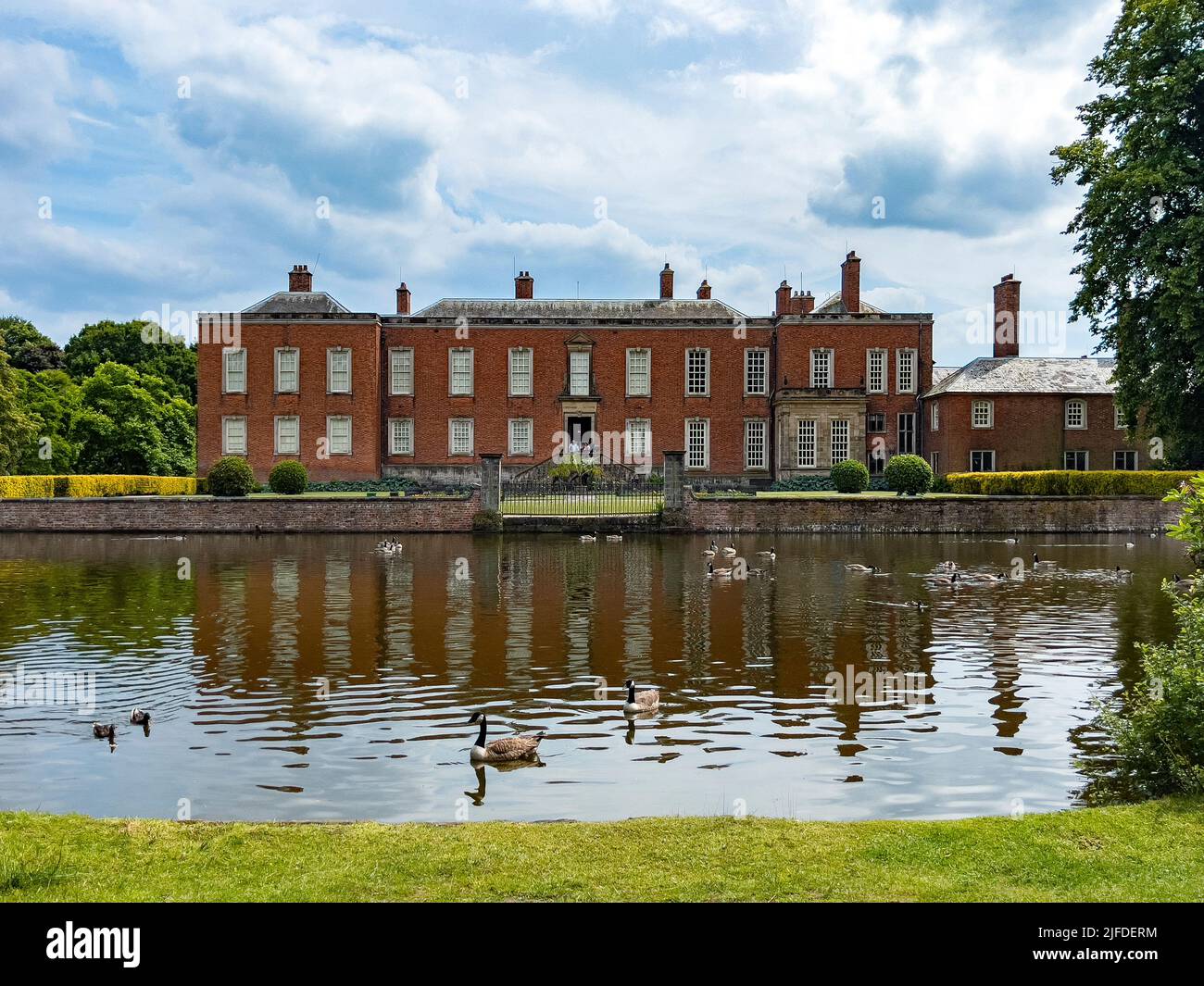 Dunham Massey Hall and moat in Greater Manchester, near Altrincham in northwest England. Stock Photo