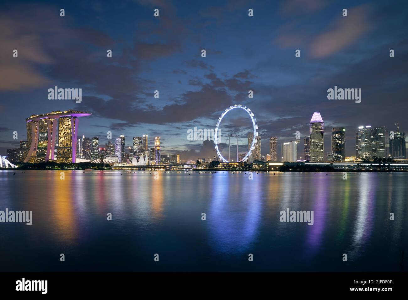 Cityscape of illuminated modern city at night. Urban skyline of Singapore. Stock Photo