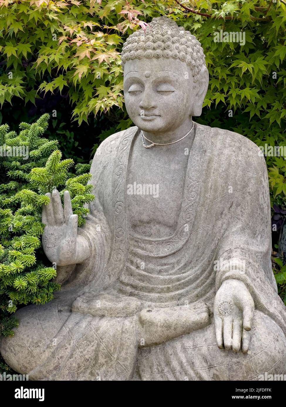 Statue of Buddha in an ornimental garden Stock Photo - Alamy