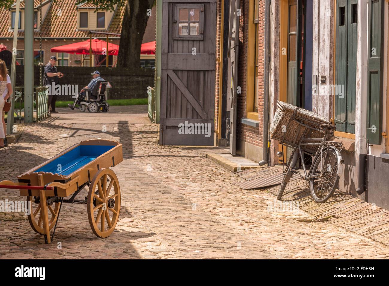 Enkhuizen, Netherlands. June 2022. Street with handcart and old bicycle in Enkhuizen. High quality photo Stock Photo