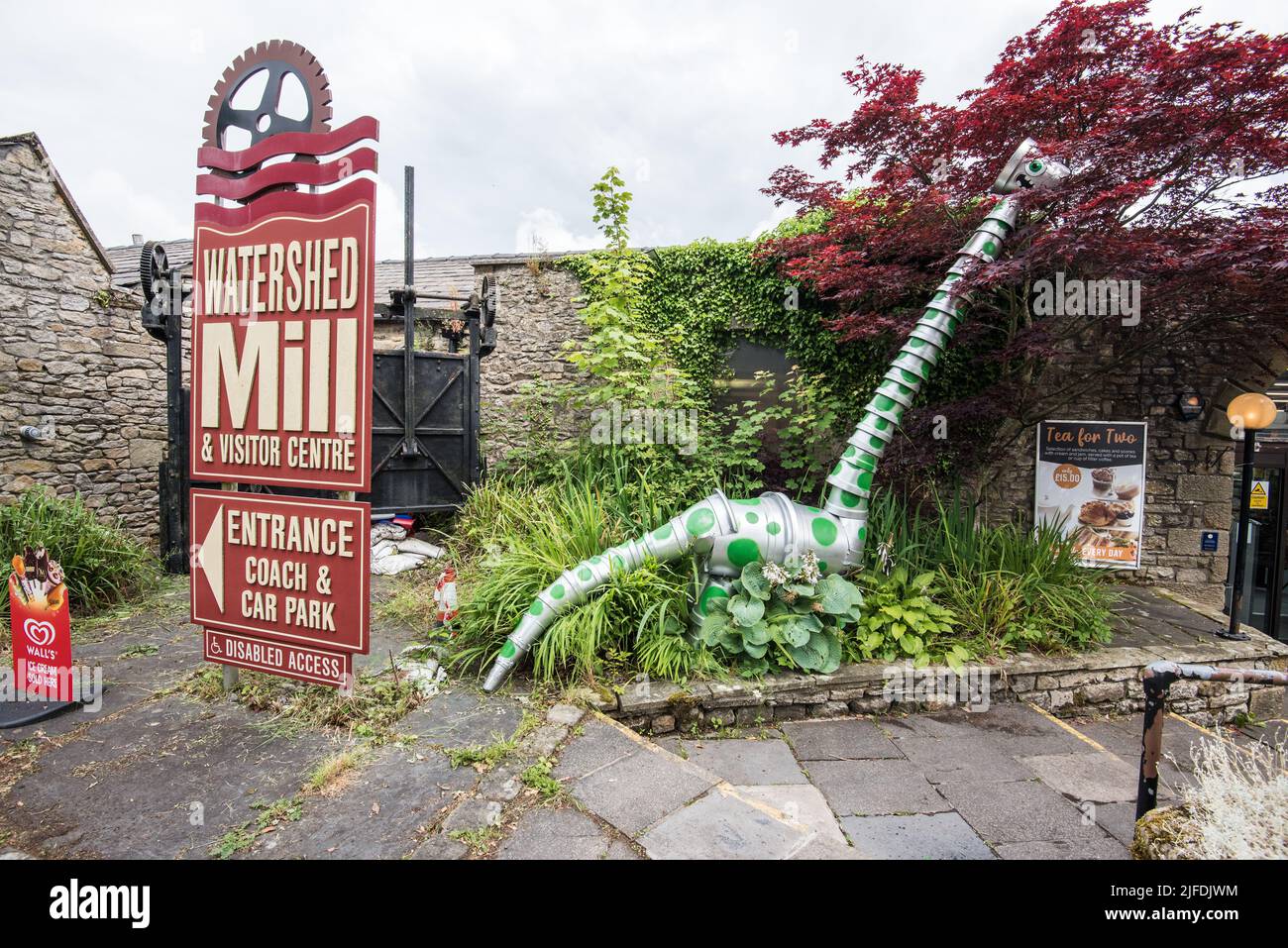 Plantpotysaurus dinosaur munches tree leaves outside Watershed Mill.........Settle Flowerpot