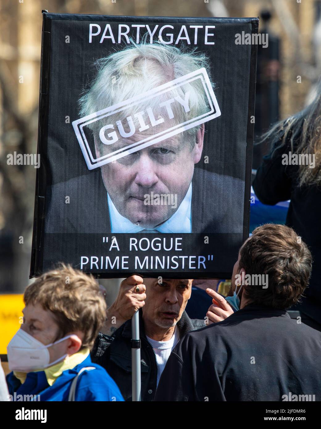 London, UK - April 20th 2022: A protester outside the Houses of Parliament in Westminster, London, protesting against Boris Johnson and the Partygate Stock Photo