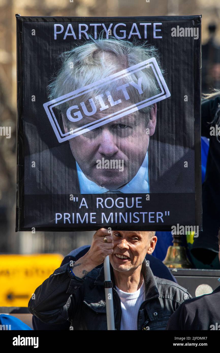 London, UK - April 20th 2022: A protester outside the Houses of Parliament in Westminster, London, protesting against Boris Johnson and the Partygate Stock Photo