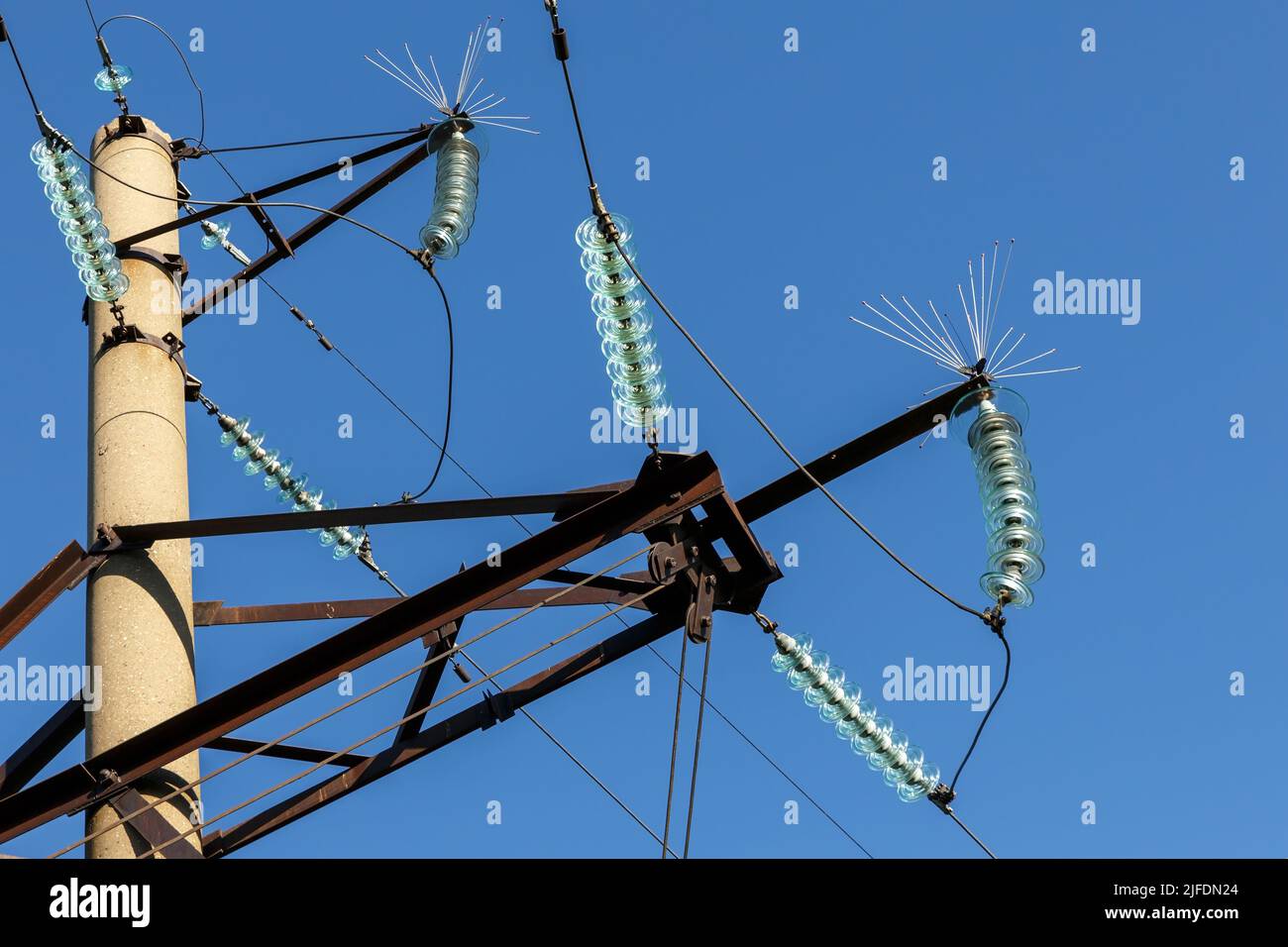 Concrete electricity pylon with glass insulators and bird spikes