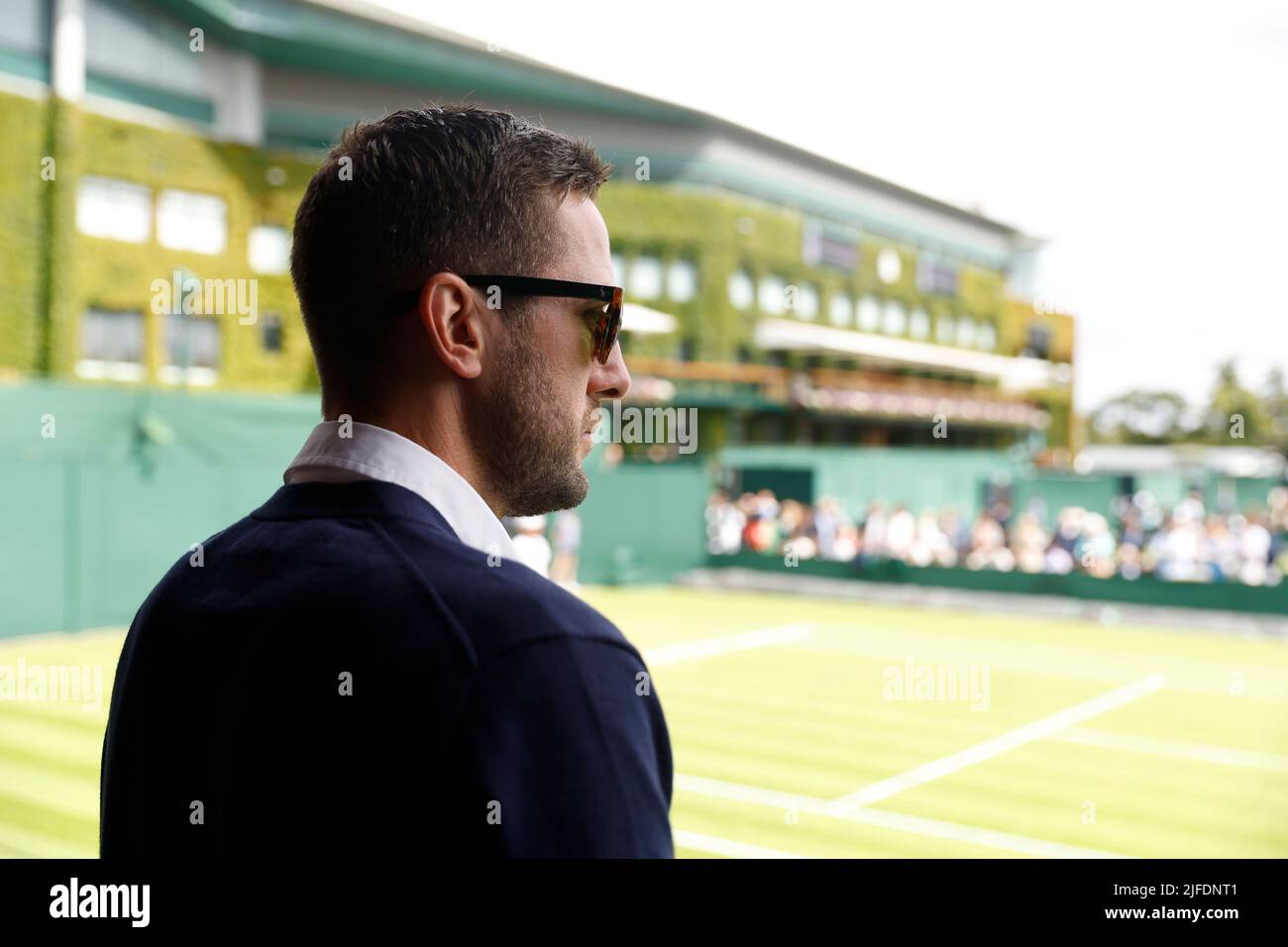 A line judge waits outside court four during day six of the 2022