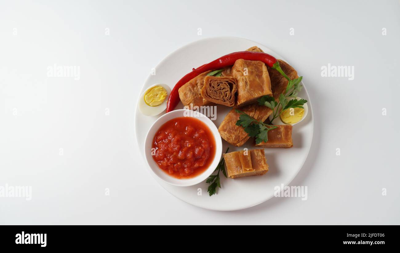 Jachnun or Jahnun, Yemenite Jewish pastry, served with fresh grated tomato and boiled egg and