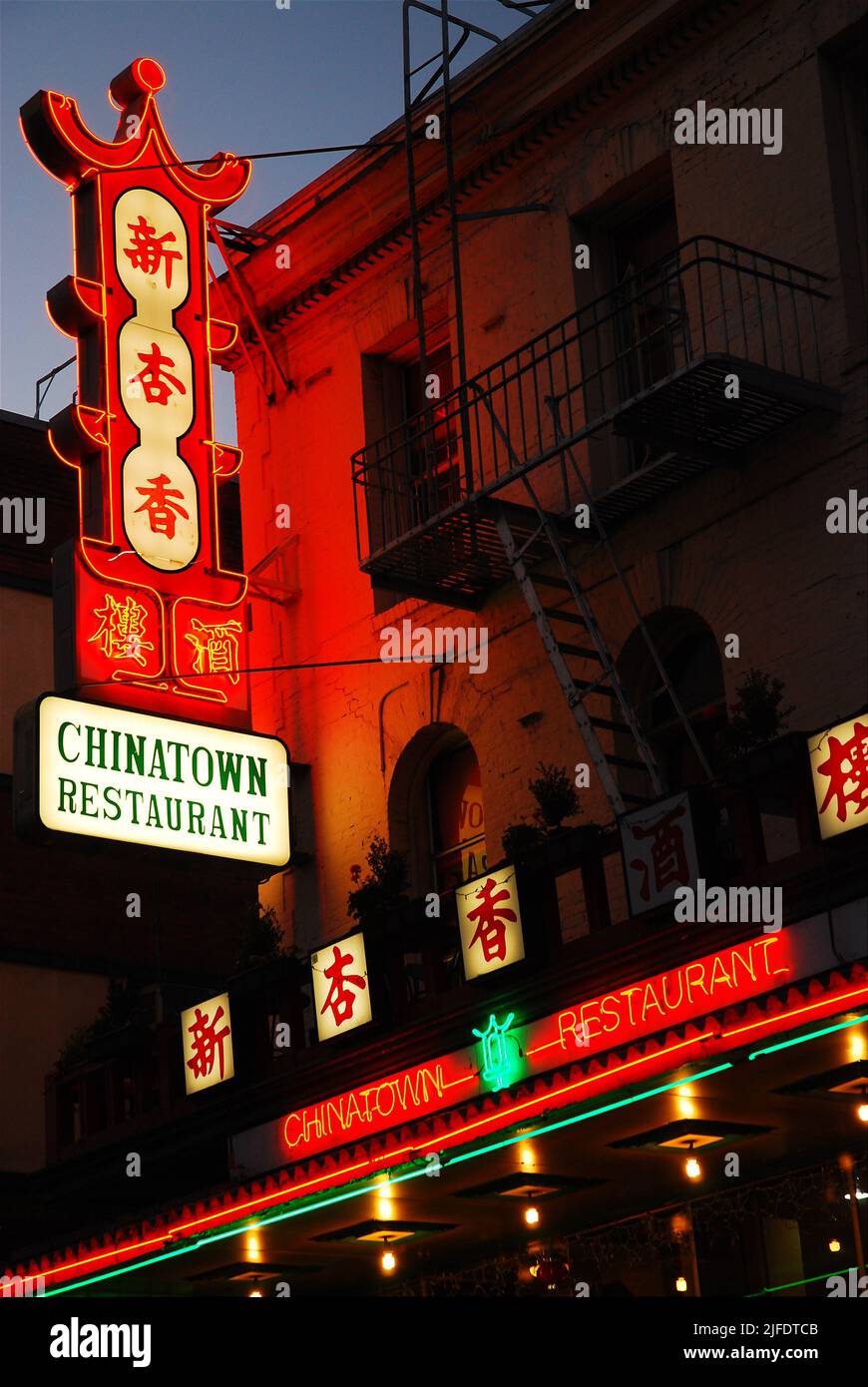 A large and bright neon light sign invites customers to try Chinese food at the Chinatown Restaurant in San Francisco Stock Photo