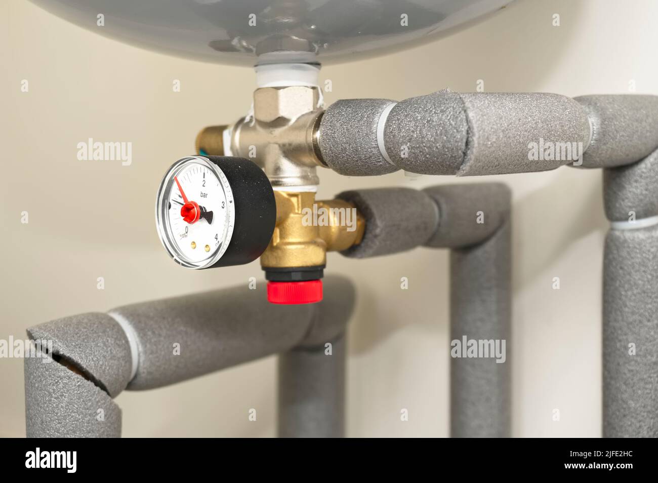 Pressure gauge on domestic boiler expansion vessel inside house Stock