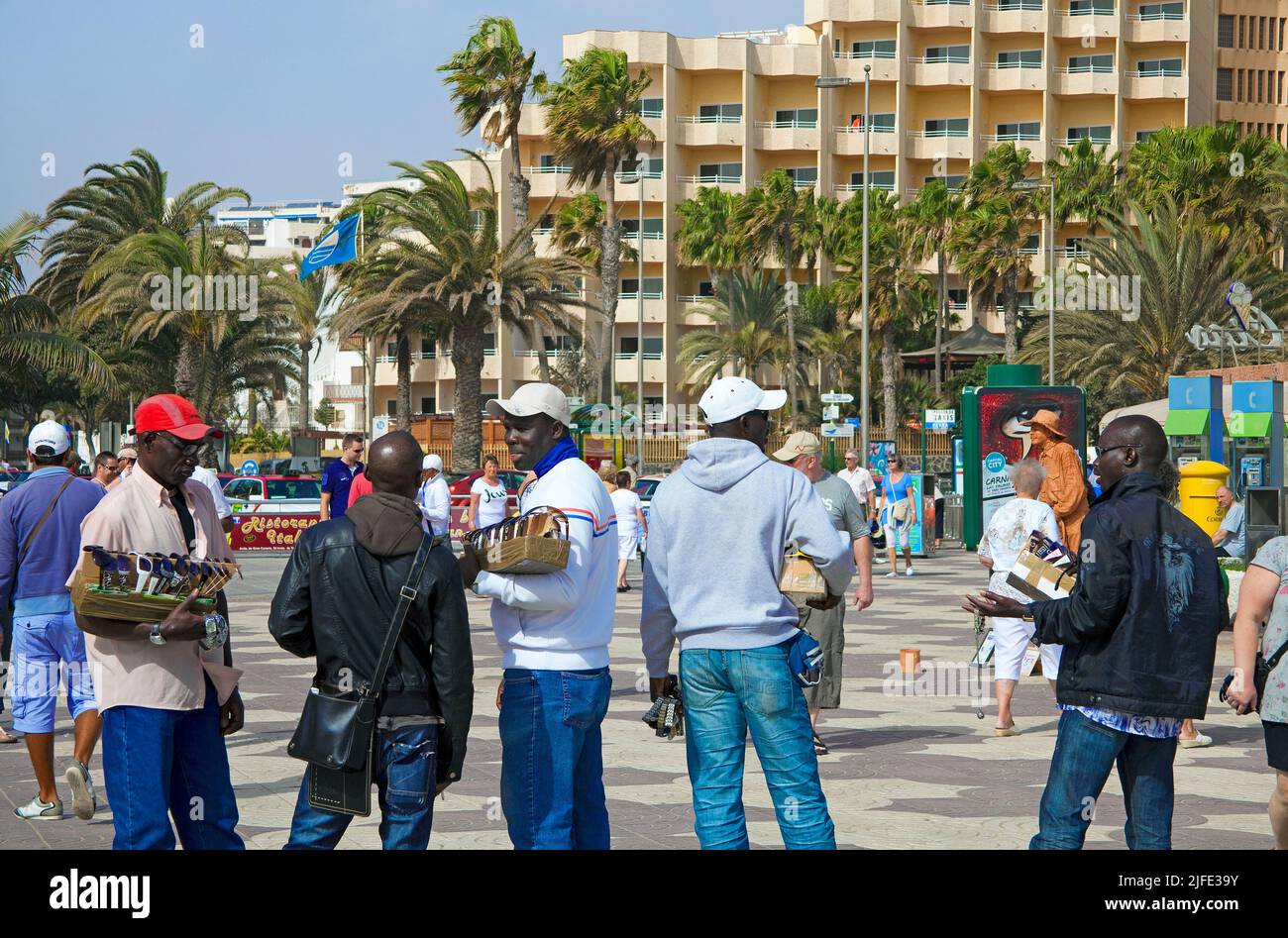 African street sellers offers watches, promenade of Playa del Ingles, Grand Canary, Canary islands, Spain, Europe Stock Photo