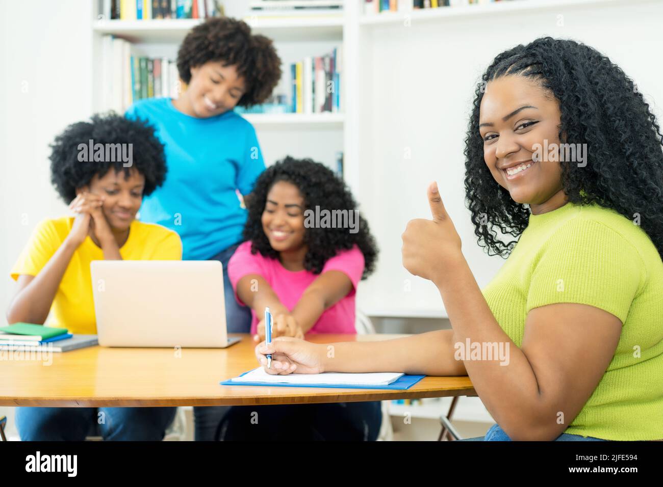 Motivated african american computer science student with group of coding students at university Stock Photo