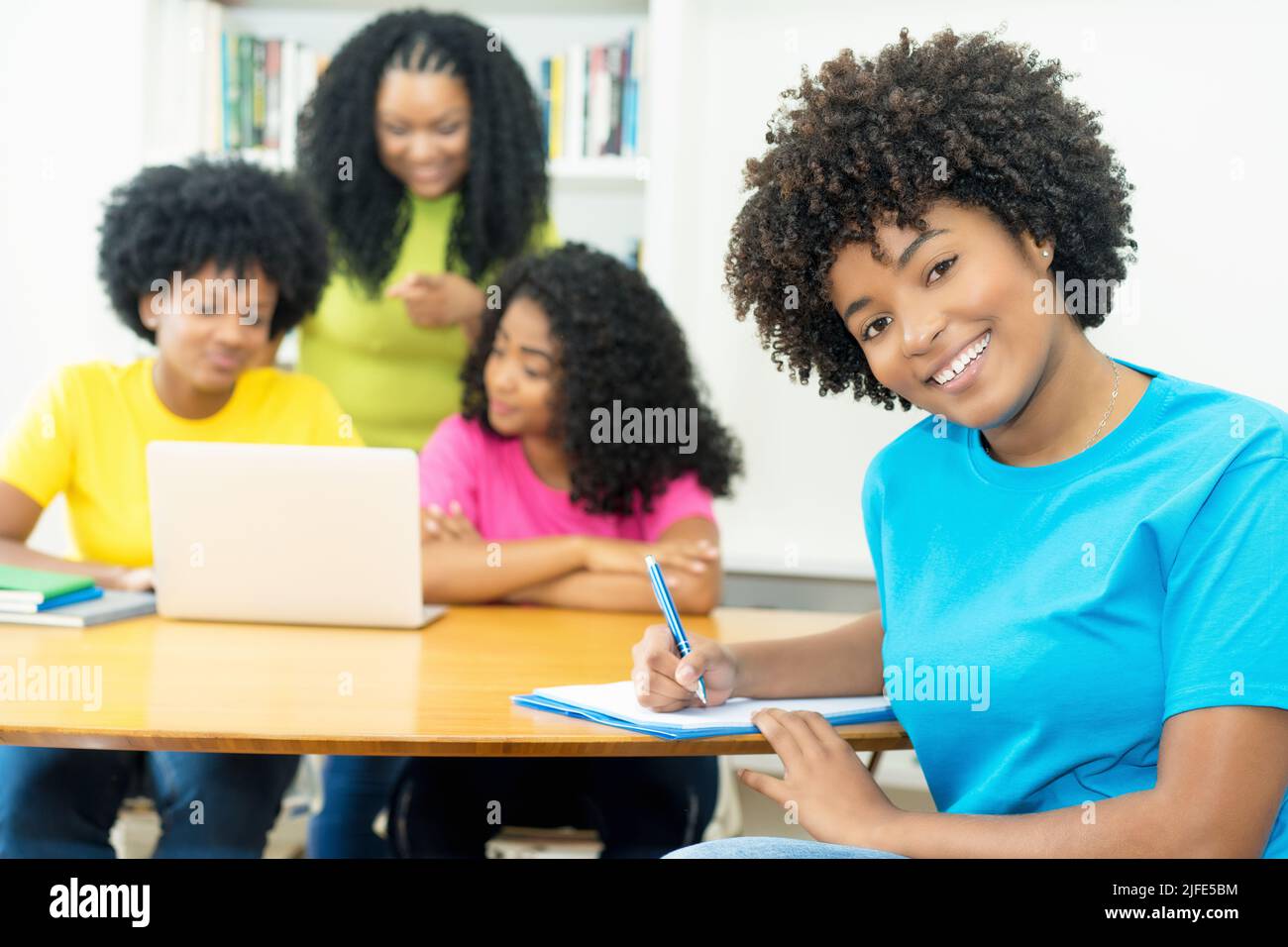 Group of happy african american computer science students learning software development and programming at university Stock Photo