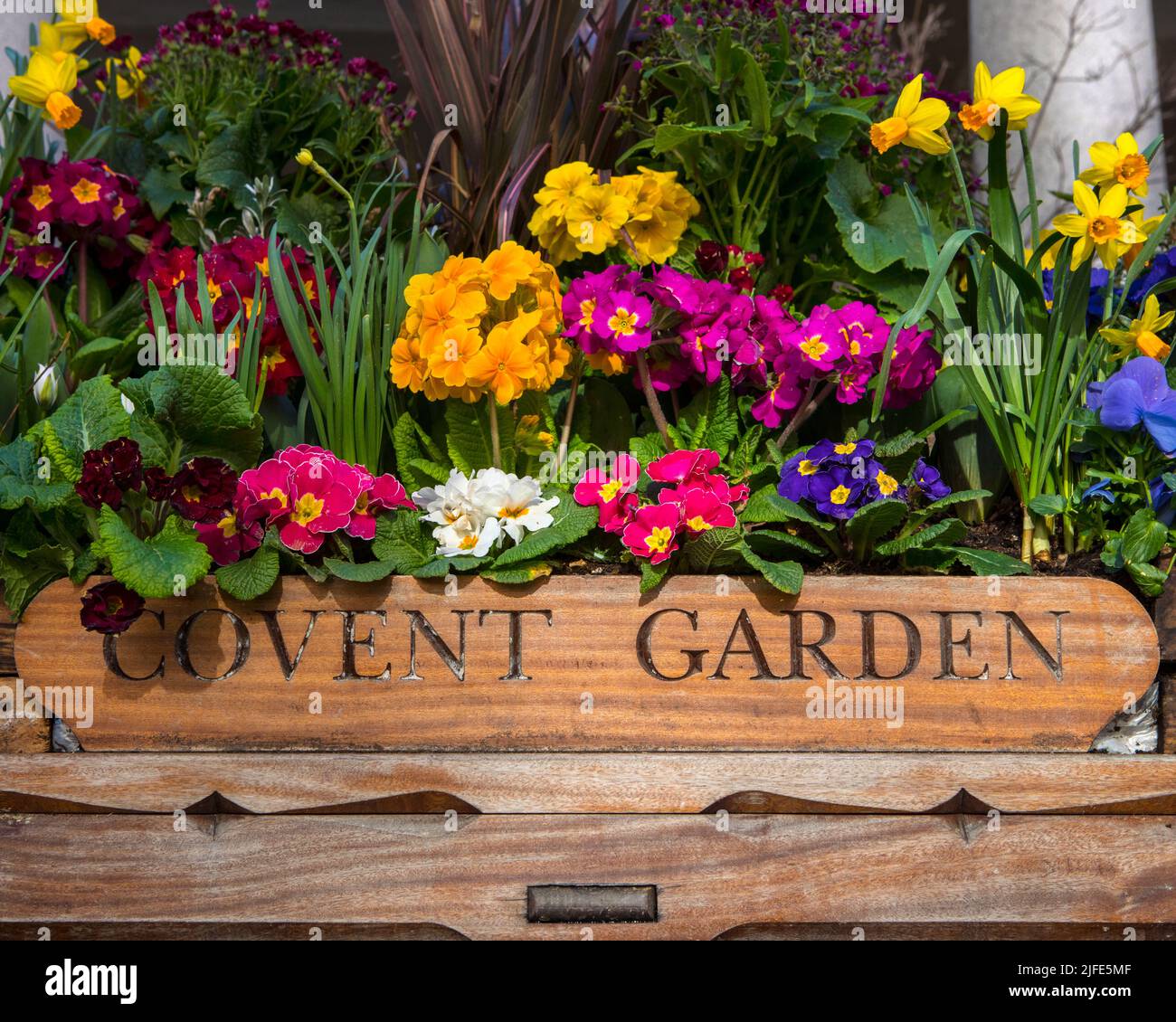 Closeup of a Covent Garden sign with beautiful flowers, in Covent