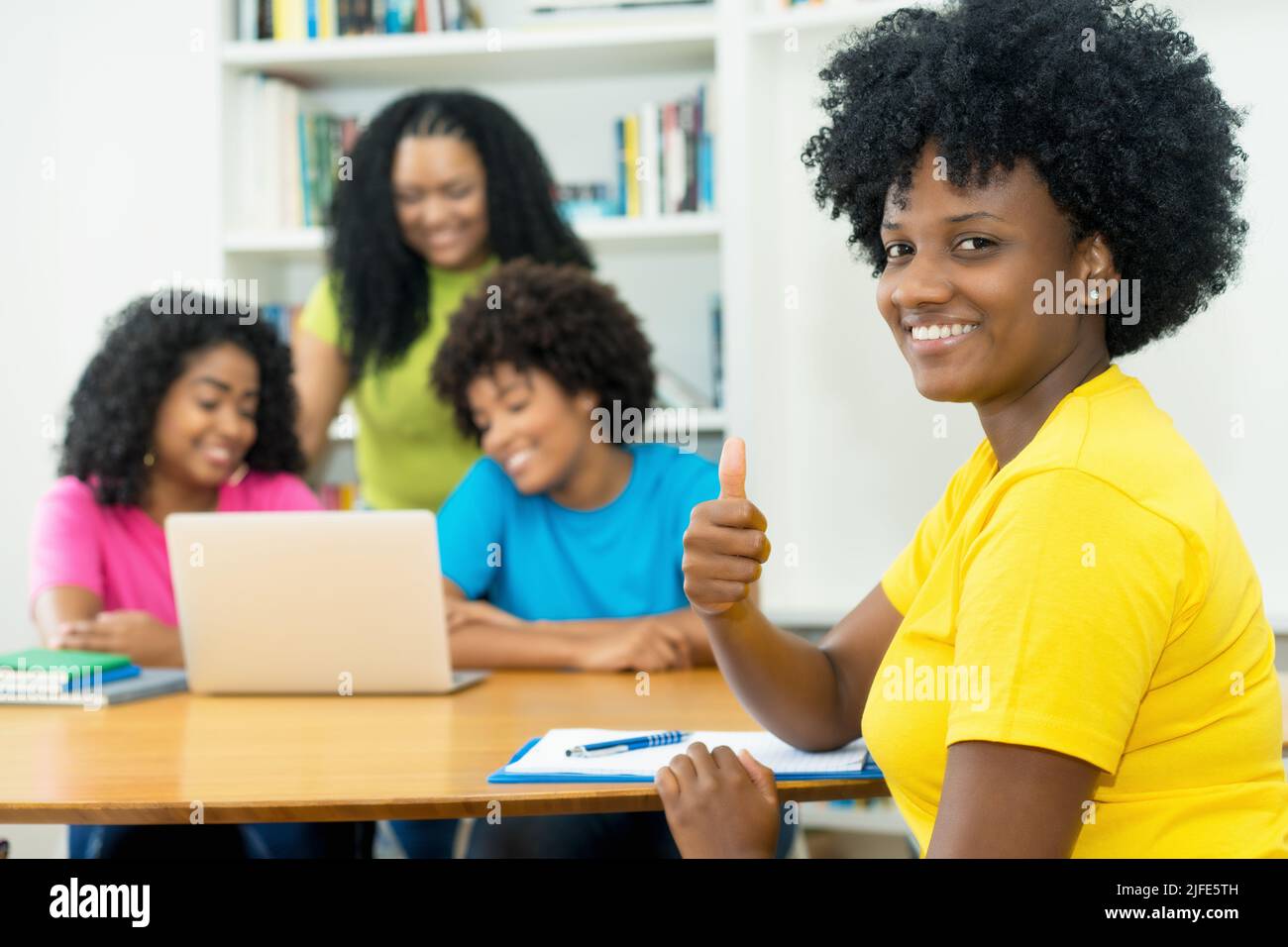 Group of laughing african american computer science students learning software development and programming at university Stock Photo