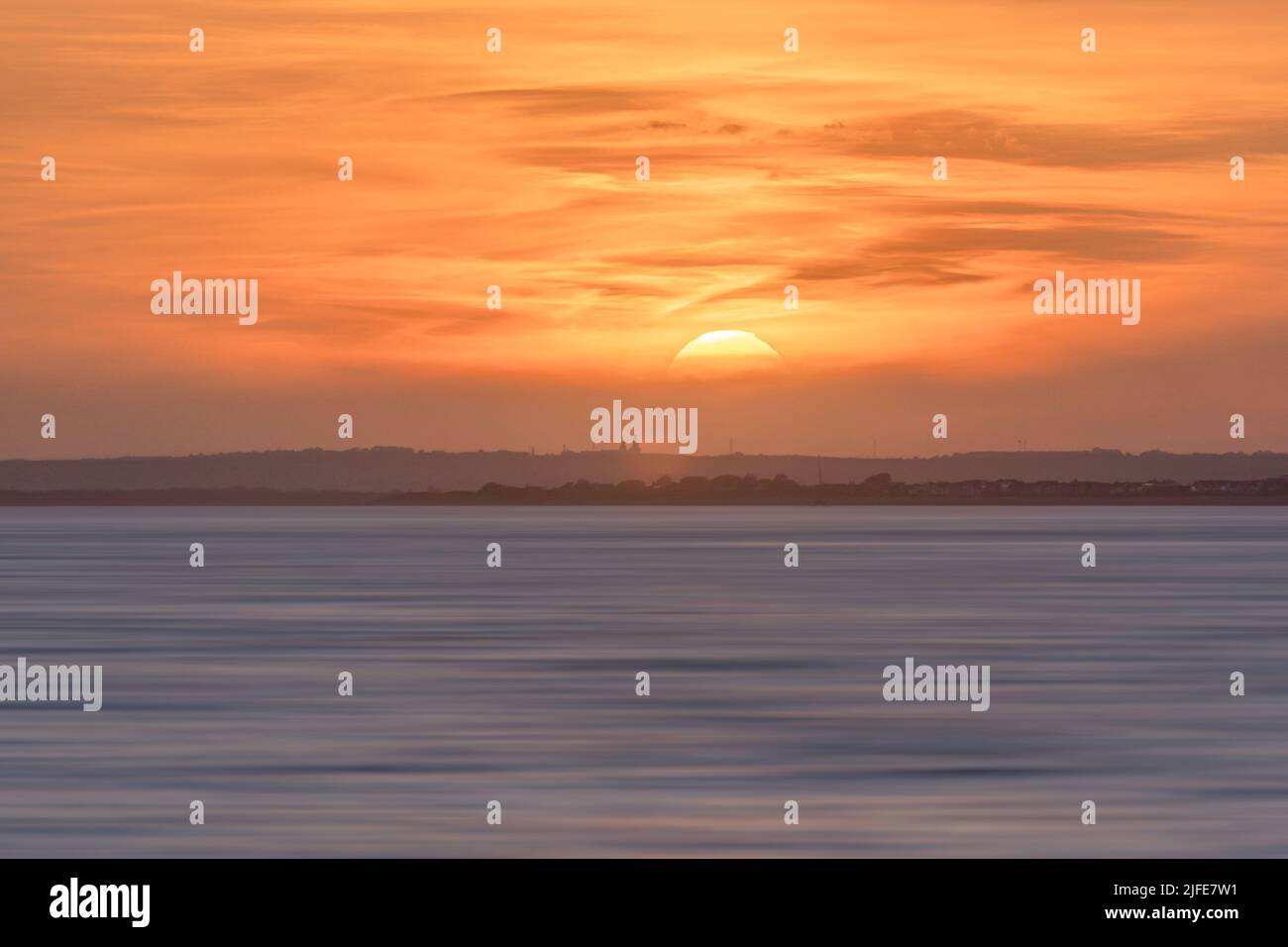 The rising sun above Bognor Regis. Stock Photo