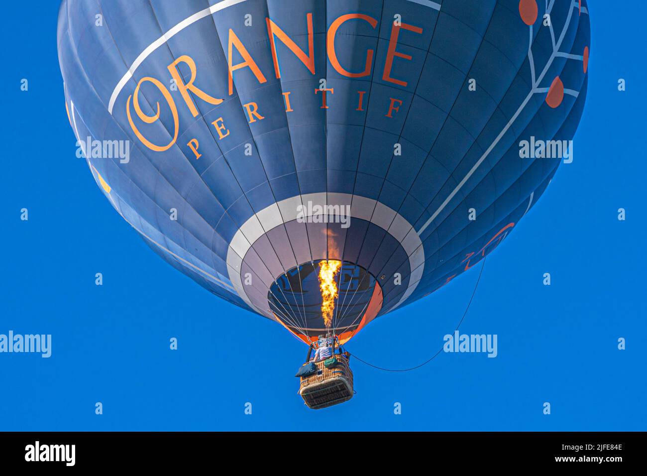 Single Hot air balloon cruising overhead on a balmy summers evening Stock Photo