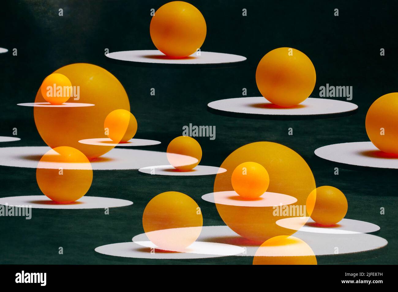 Abstract still life with orange balls on white sands suspended in the