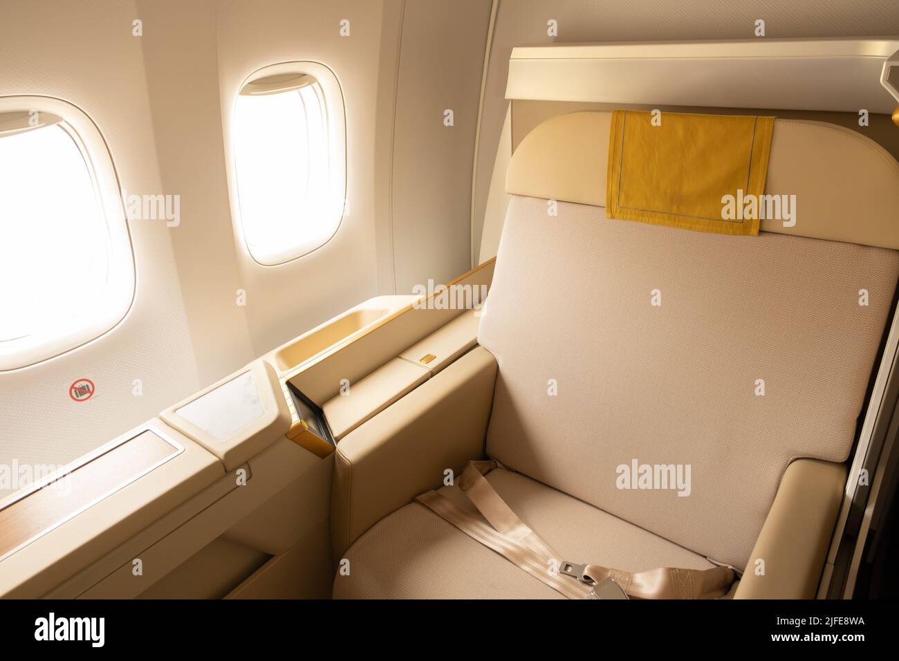 Luxury first or business class suite on airplane in gold color feel private for travel. Business comfort and elegance chair when fly with airline Stock Photo