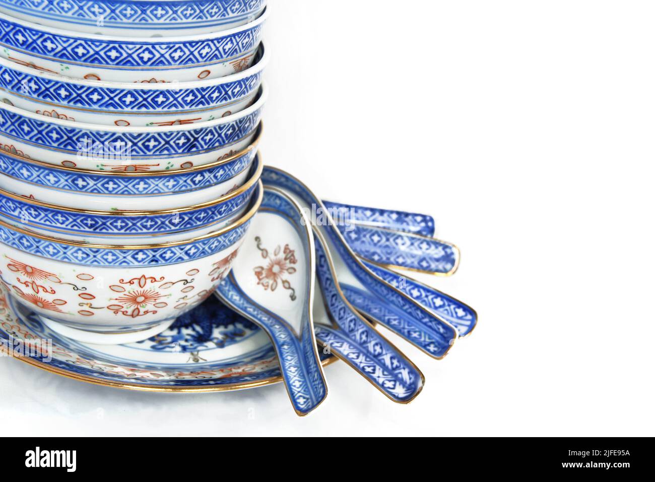 Pile of Bowls and spoons of Asian cuisine, with copy space for menu