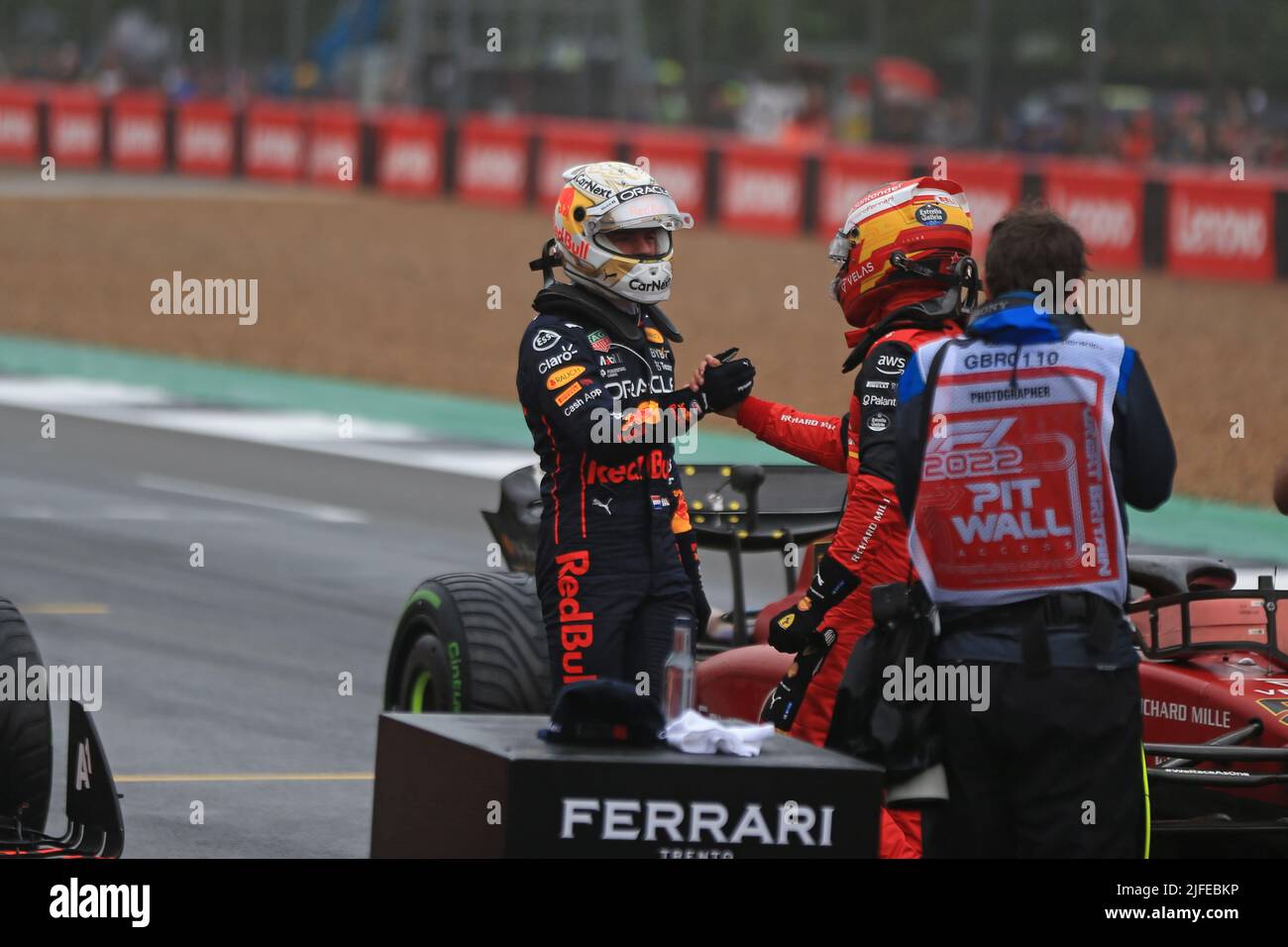 2nd July 2022, Silverstone Circuit, Silverstone, Northamptonshire, England: British F1 Grand Prix, qualifying day: Oracle Red Bull Racing, Max Verstappen shakes hands with pole winner of Scuderia Ferrari, Carlos Sainz Stock Photo