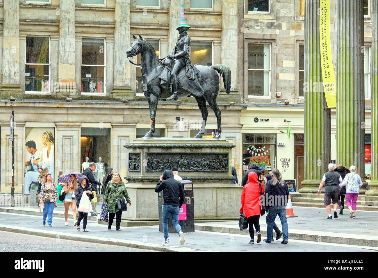 Glasgow, Scotland, UK 2nd July, 2022. Cone headed man gets transgender hat as the symbol for the city the duke of wellington statue gets a hat for gay week in transgender colours. Transgender Pride Flag was created by American trans woman Monica Helms in 1999, and was first shown at a pride parade in Phoenix, Arizona, United States in 2000 Credit Gerard Ferry/Alamy Live News Stock Photo