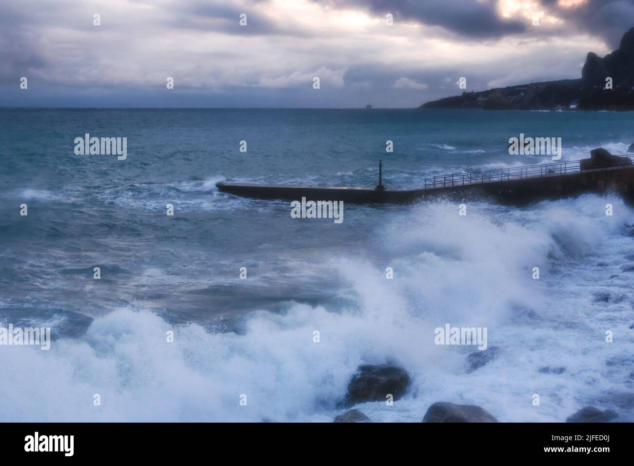 Storm at sea with waves during rain and cloudy in spring in Alupka. Crimea Stock Photo