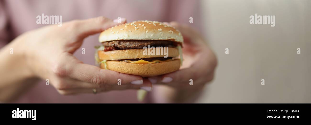 Woman going to eat cheeseburger Stock Photo