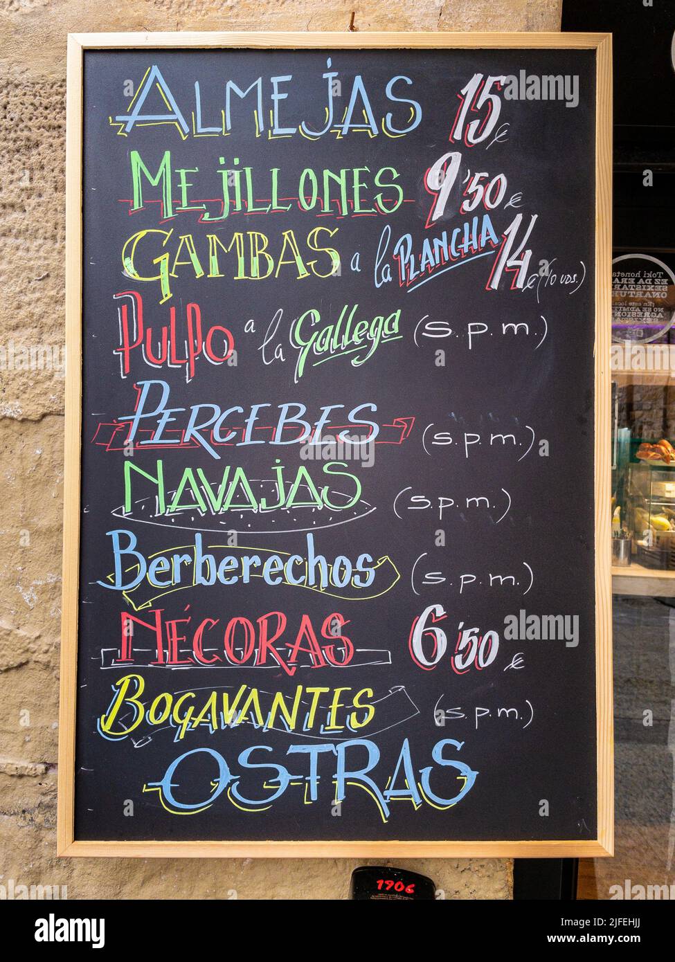 A blackboard menu offering typical Spanish seafood. Stock Photo