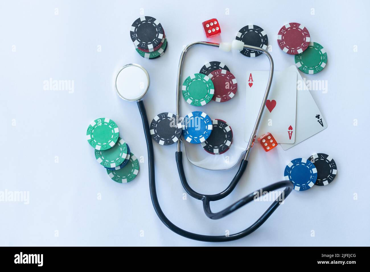 Medical risk concept, stethoscope with poker chip Stock Photo