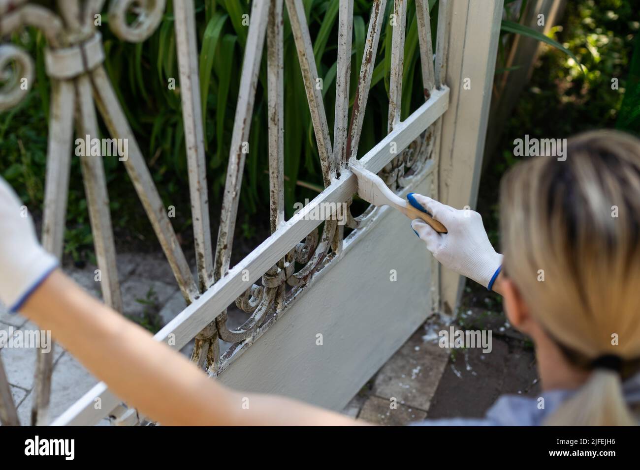 Hand wearing white gloves and painting with a paint brush Stock Photo Alamy