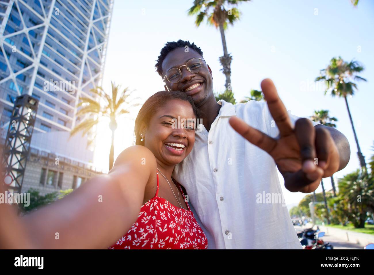 Selfie of a young black couple looking at camera smiling. Concept of vacation and relationship. African American couple having fun enjoying holidays Stock Photo