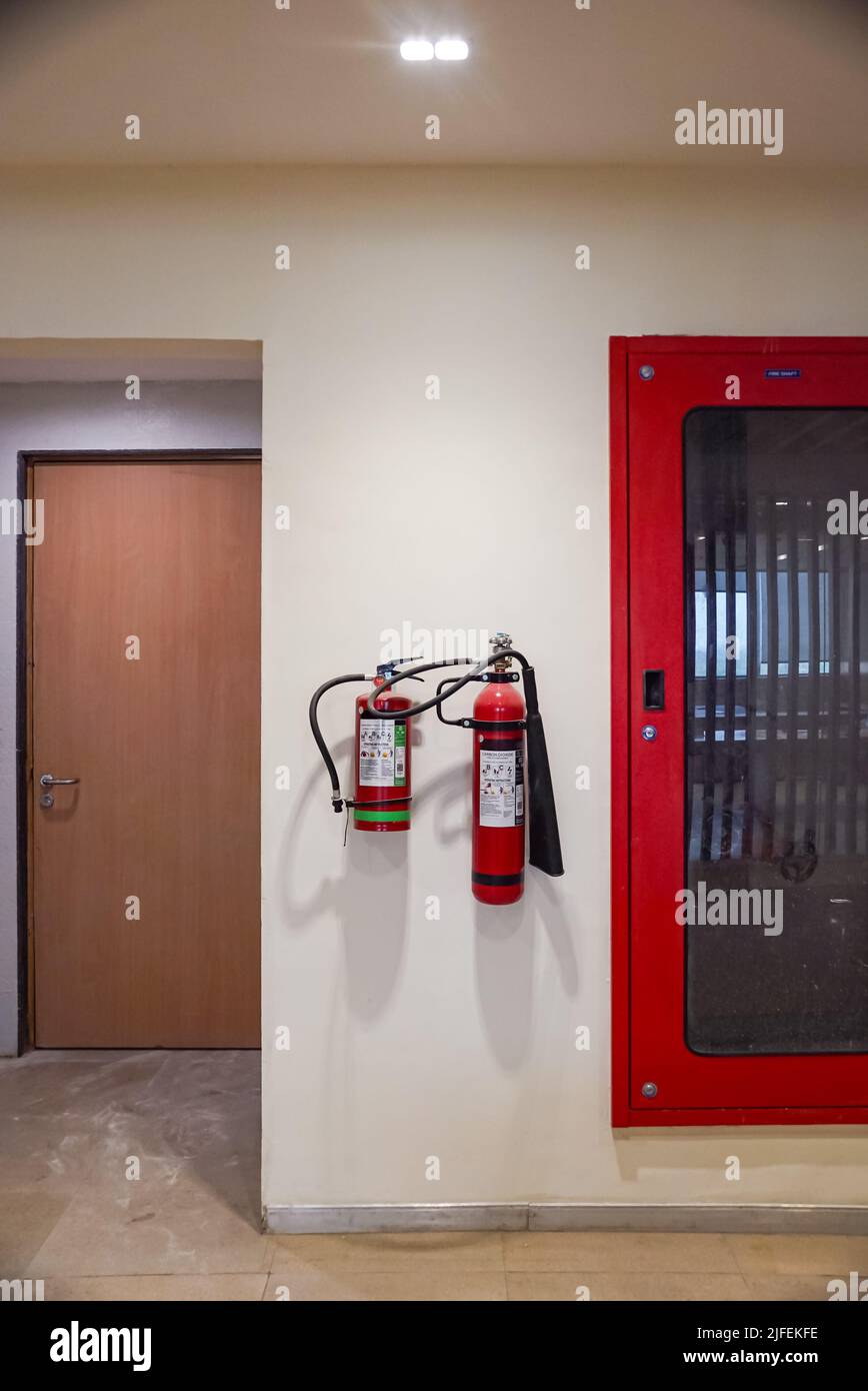 Fire extinguisher and gas pump system on the wall. Powerful emergency