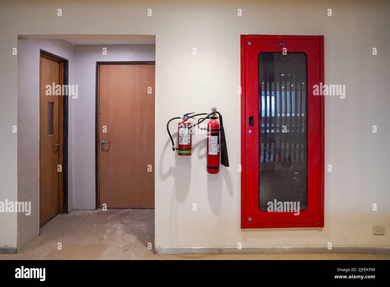 Fire extinguisher and gas pump system on the wall. Powerful emergency