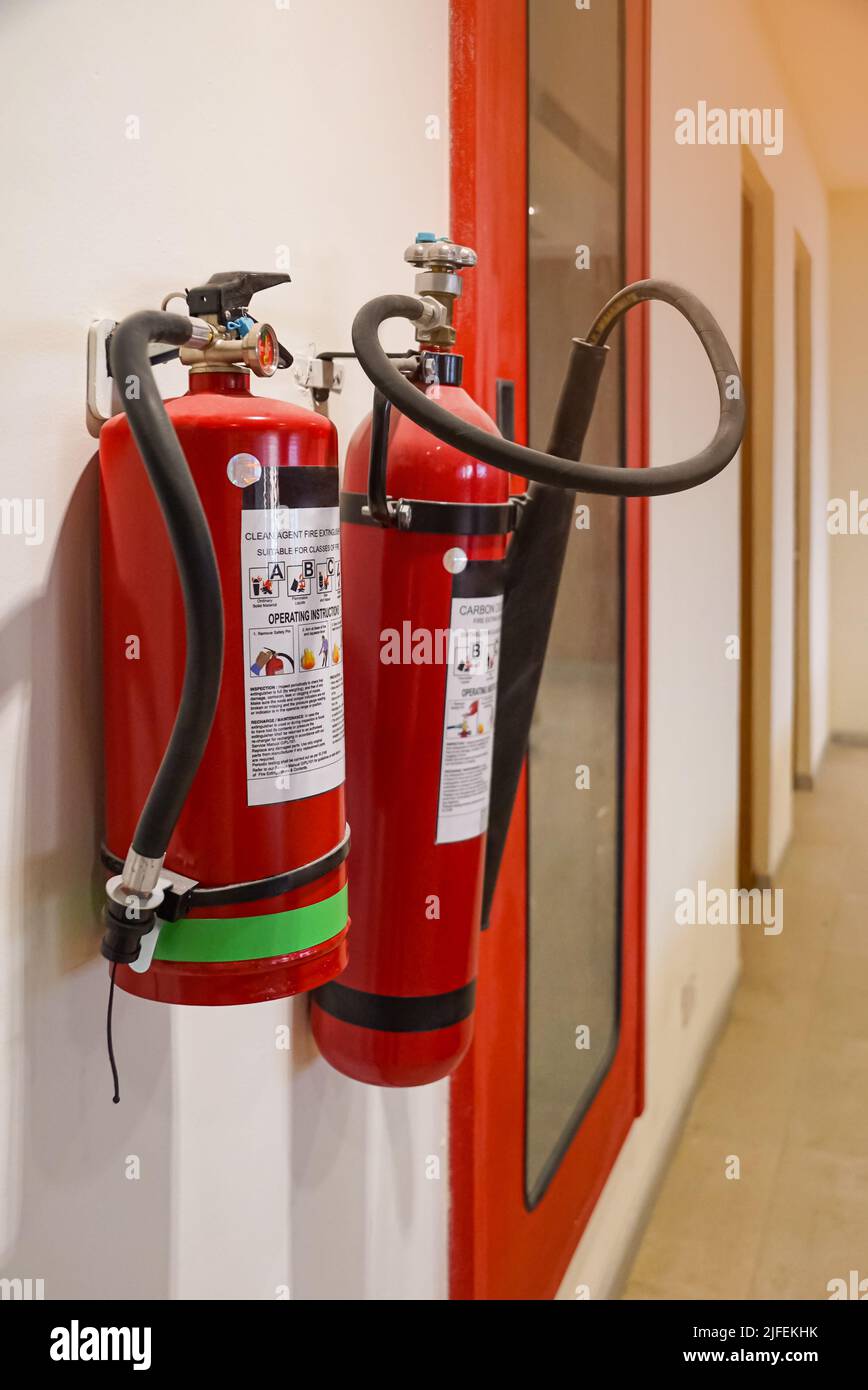 Fire extinguisher and gas pump system on the wall. Powerful emergency