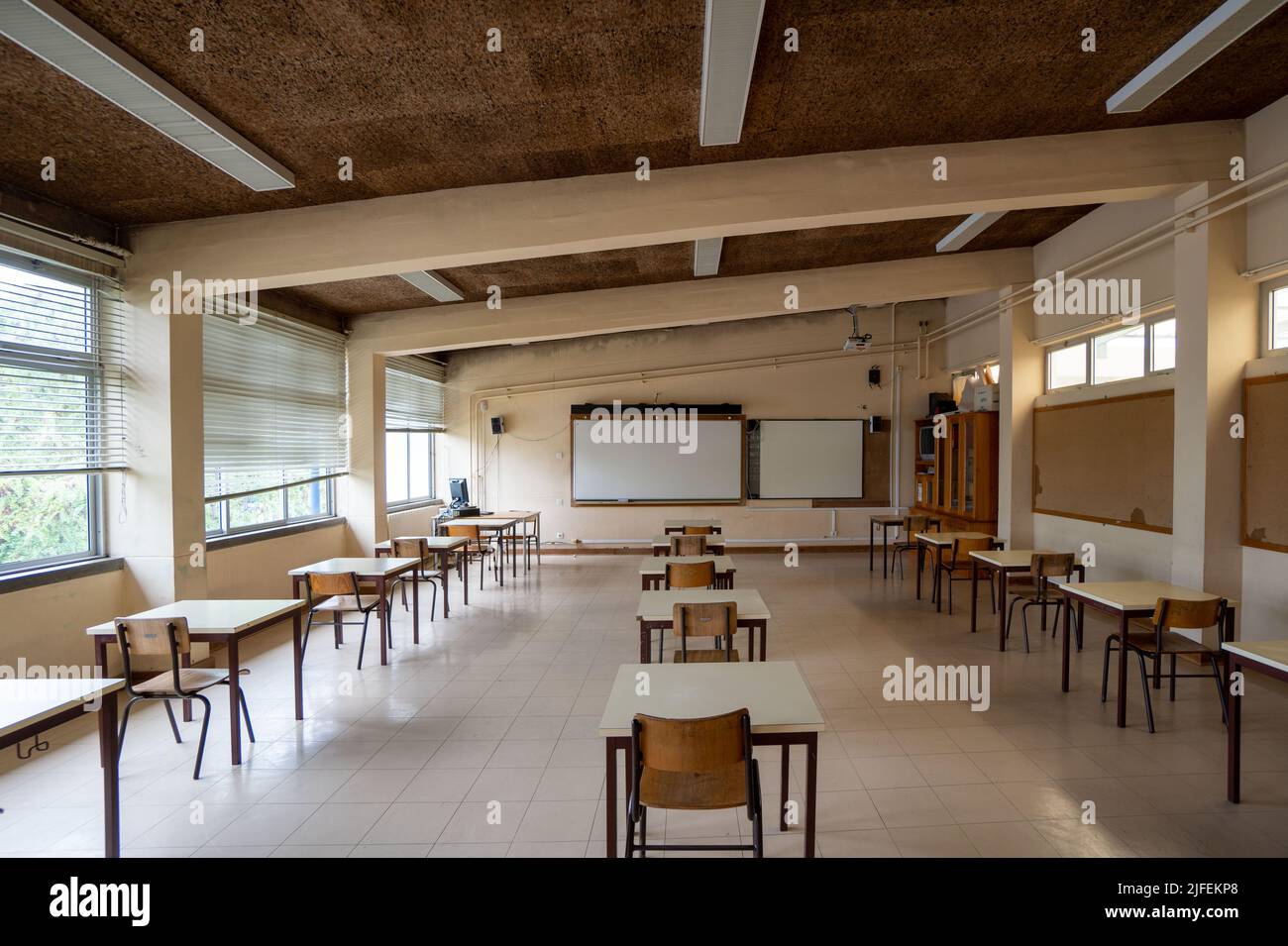 Empty classroom with desks far apart Stock Photo