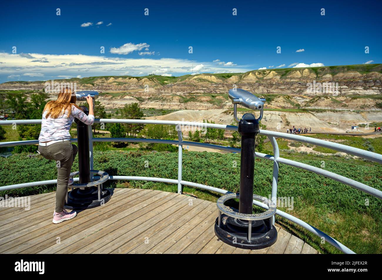 Tourists observing the landscape of the Canadian Badlands via binocular in Drumheller, the dinosaur capital of the world, Alberta, Canada Stock Photo
